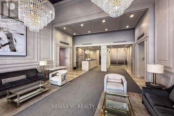 Toronto (Willowdale East) condo for rent - A well-lit, elegant living room with a grey carpet and a chandelier.