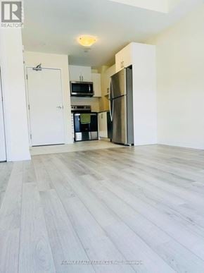 Toronto (Malvern) townhouse for rent - A kitchen with a refrigerator, microwave, and oven.