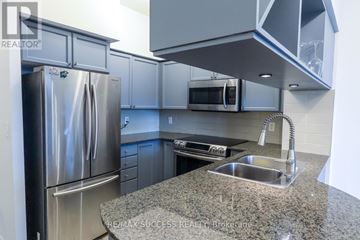Mississauga (City Centre) condo for rent - A kitchen with a granite countertop and stainless steel appliances.
