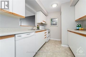 Ottawa condo for rent - A white kitchen with a dishwasher and a refrigerator.