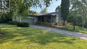 Richmond Hill (South Richvale) apartment for rent - A house with a driveway and green grass in front.