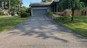Richmond Hill (South Richvale) apartment for rent - A residential driveway with a house and garage in the background.
