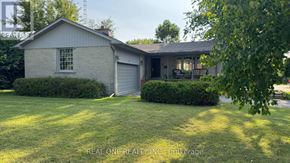 Richmond Hill (South Richvale) apartment for rent - A house with a garage and a well-kept lawn.