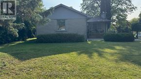 Richmond Hill (South Richvale) apartment for rent - A house with a well-maintained lawn in front of it.