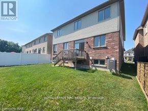 Niagara Falls (Brown) apartment for rent - A house with a lawn in front of it is for sale.