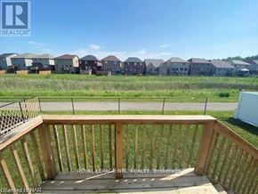 Niagara Falls (Brown) apartment for rent - A wooden deck overlooks a grassy field with houses in the distance.