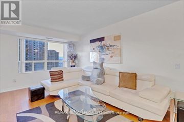 Mississauga (City Centre) condo for rent - A living room with a glass coffee table and a white couch.