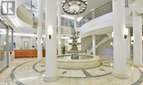 Mississauga (City Centre) condo for rent - A grand foyer with a fountain, columns, and a chandelier.