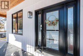 West Grey apartment for rent - A white building with a black door and a wreath on the glass.