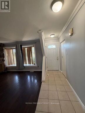 Brampton (Avondale) apartment for rent - A hallway with a white door and a light on the wall.