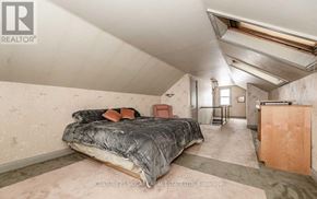 Brampton (Downtown Brampton) apartment for rent - A bedroom with a bed, dresser, and mirror.