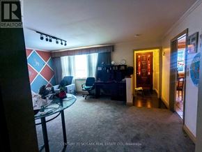 Brampton (Downtown Brampton) apartment for rent - A living room with a glass table and a blue couch.
