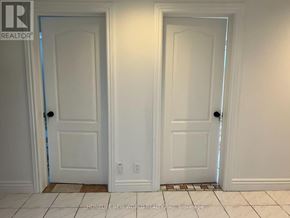 Toronto (Willowdale East) apartment for rent - Two white doors in a room with tile flooring.