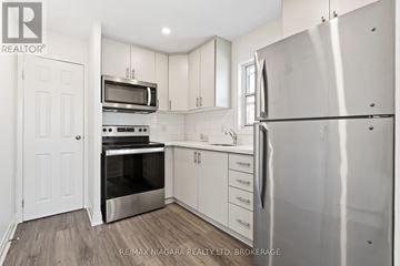 St. Catharines (E. Chester) apartment for rent - A kitchen with white cabinets and stainless steel appliances.