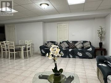 Markham (Milliken Mills East) apartment for rent - A living room with a grey couch and a glass table with a flower vase on it.