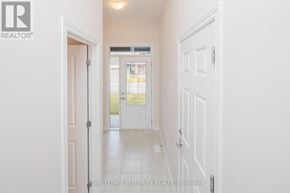 Clarence-Rockland townhouse for rent - A white hallway with a door on the left and a door on the right.