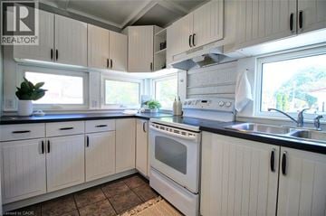 Hamilton apartment for rent - A kitchen with white cabinets and a black countertop.