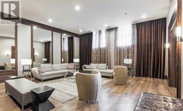 Toronto (Waterfront Communities) condo for rent - A modern living room with a large sofa set and a coffee table.