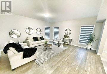 Welland (Lincoln/Crowland) apartment for rent - A living room with a white couch and a wooden floor.
