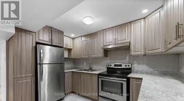 Ajax (Northwest Ajax) apartment for rent - A kitchen with wooden cabinets and stainless steel appliances.