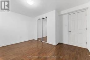 Ajax (Northwest Ajax) apartment for rent - A white room with a wooden floor and a sliding door.