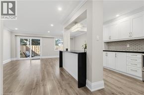 Burlington townhouse for rent - A spacious kitchen with white cabinets and a black island.