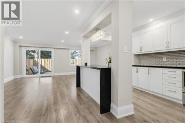 Burlington townhouse for rent - A spacious kitchen with white cabinets and a black island.