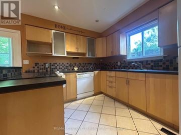 London North (North K) apartment for rent - A kitchen with wooden cabinets and a black counter top.
