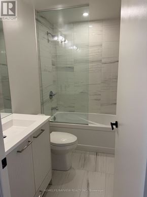 Oshawa (Windfields) condo for rent - A white bathroom with a glass shower door.