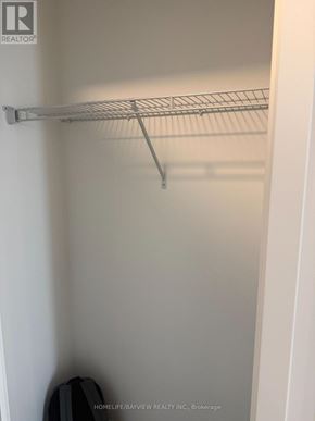 Oshawa (Windfields) condo for rent - A white closet with a metal rack.
