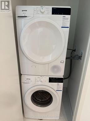 Oshawa (Windfields) condo for rent - A white Gorenje washing machine and dryer in a small laundry room.
