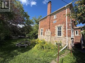 Toronto (Bedford Park-Nortown) multi-family for rent - A brick house with a chimney and a sign that says "REALTOR".