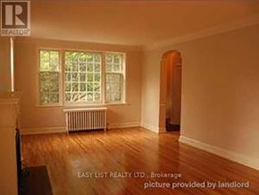 Toronto (Bedford Park-Nortown) duplex for rent - A room with a window and a radiator is for sale.