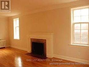 Toronto (Bedford Park-Nortown) duplex for rent - A room with a fireplace and a window.