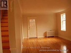 Toronto (Bedford Park-Nortown) duplex for rent - A room with a white door and a window with wooden floors.