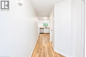 Waterloo apartment for rent - A long hallway with wood floors and white walls.