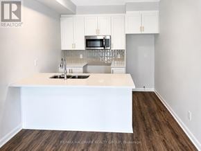 Ottawa townhouse for rent - A kitchen with white cabinets and a white island.