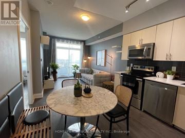 Vaughan (Beverley Glen) condo for rent - A modern kitchen with a dining table and chairs in the foreground.