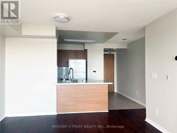 Toronto (Willowdale West) condo for rent - A kitchen area with a sink and a refrigerator.