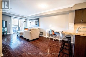Burlington (Alton) condo for rent - A living room with a white couch and a wooden floor.
