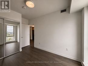 Toronto (Regent Park) condo for rent - A room with a sliding glass door leading to a balcony, a ceiling light, and a wall-mounted air vent.