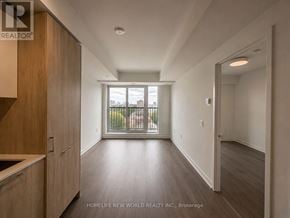 Toronto (Regent Park) condo for rent - A spacious room with wooden floors and a large window overlooking a balcony.