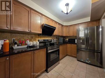 Richmond Hill (Westbrook) apartment for rent - A kitchen with wooden cabinets and a stainless steel refrigerator.