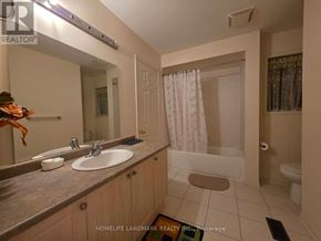 Richmond Hill (Westbrook) apartment for rent - A bathroom with a sink, mirror, and shower.