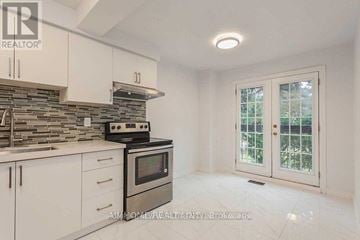 Toronto (L'amoreaux) townhouse for rent - A kitchen with a stove, oven, and cabinets.