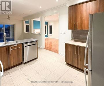 Toronto (Humberlea-Pelmo Park) apartment for rent - A kitchen with wooden cabinets and a refrigerator.