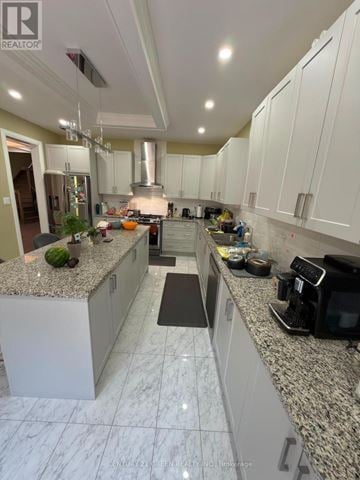 Caledon apartment for rent - A well-lit kitchen with white cabinets and a marble countertop.