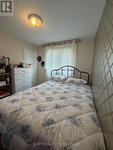 Welland (N. Welland) apartment for rent - A bedroom with a bed, dresser, and window.