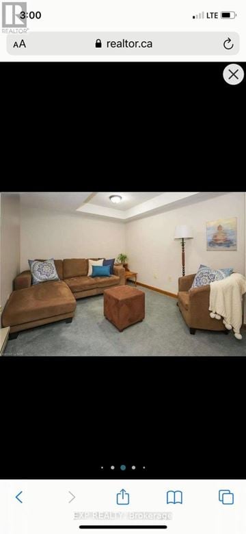 Welland (N. Welland) apartment for rent - A living room with a brown leather sofa and a wooden coffee table.