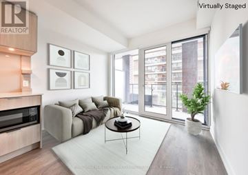 Mississauga (Port Credit) condo for rent - A living room with a couch, a coffee table, and a television.